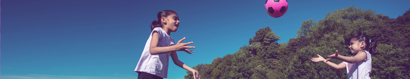 Sisters playing with ball
